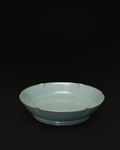 Angled front view of a celadon Chinese brush washer with a six-lobed mallow-shaped rim.