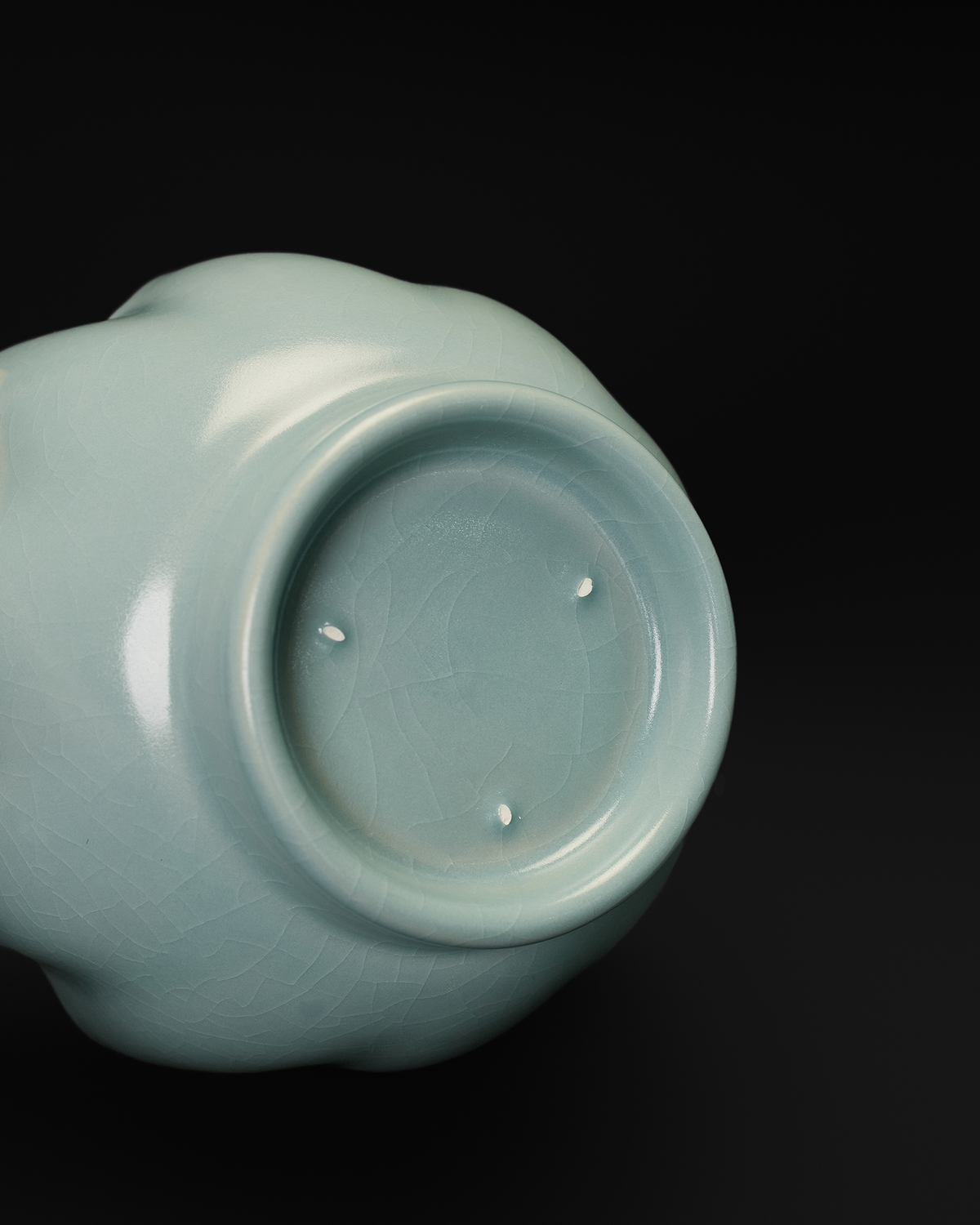 Base close-up of the Chinese celadon bowl showing the foot ring and three visible spur marks.