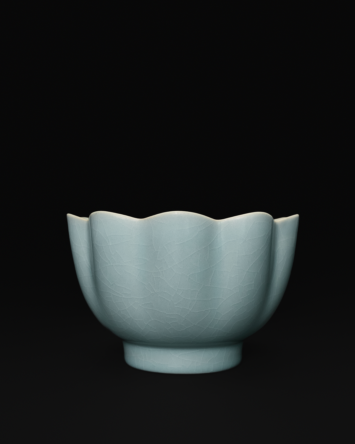 Front view of a Chinese celadon lotus bowl with petal-shaped sides and fine crackle glaze.