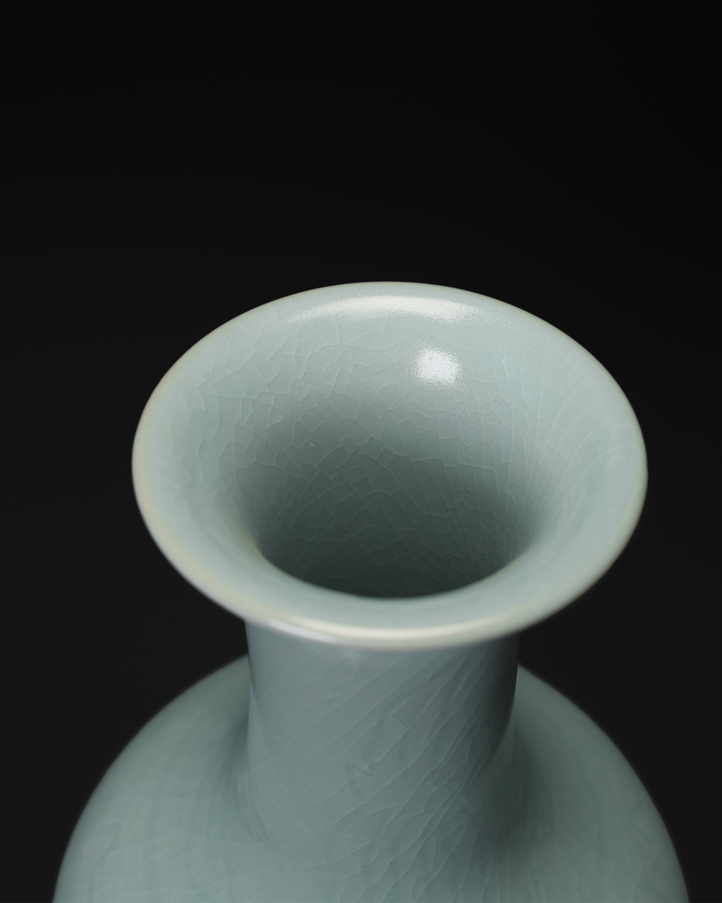 Angled top view of the vase neck and rim with visible crackle lines in the celadon glaze.
