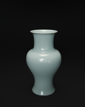 Front view of a celadon Guanyin vase with a flared rim, rounded shoulders and a waisted body.