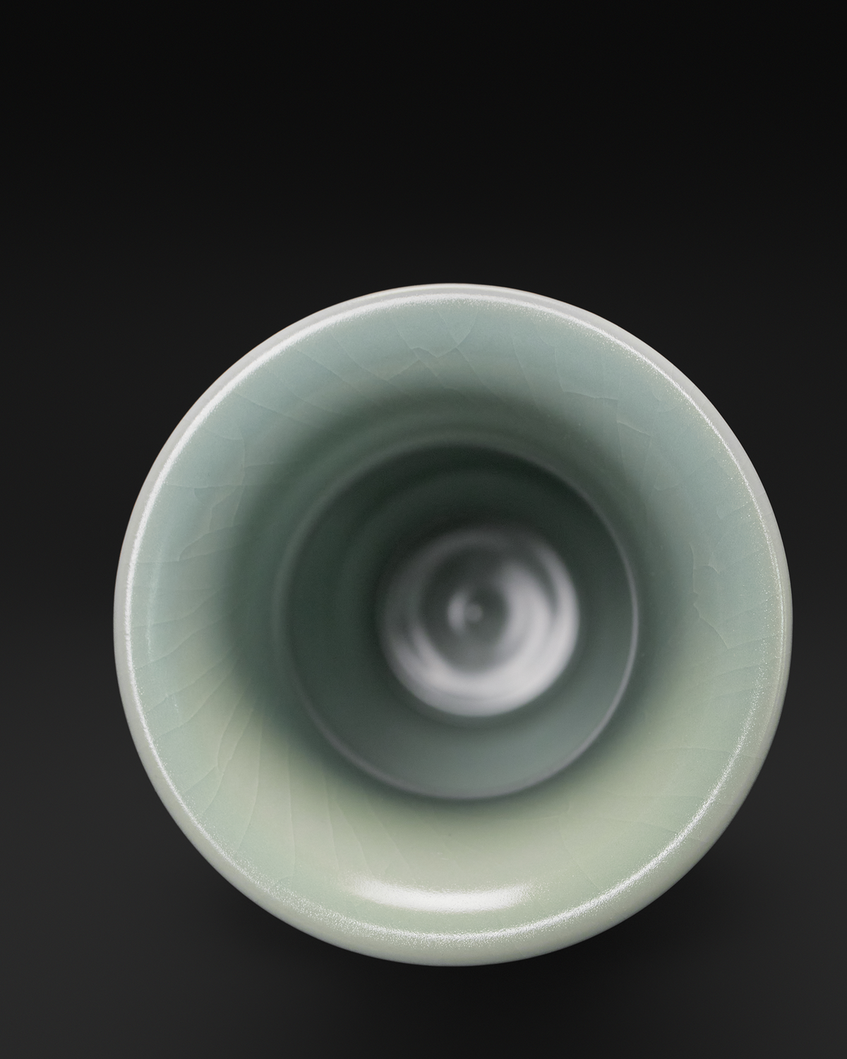 Top-down view into the flared opening and narrow interior of the celadon Guanyin vase.