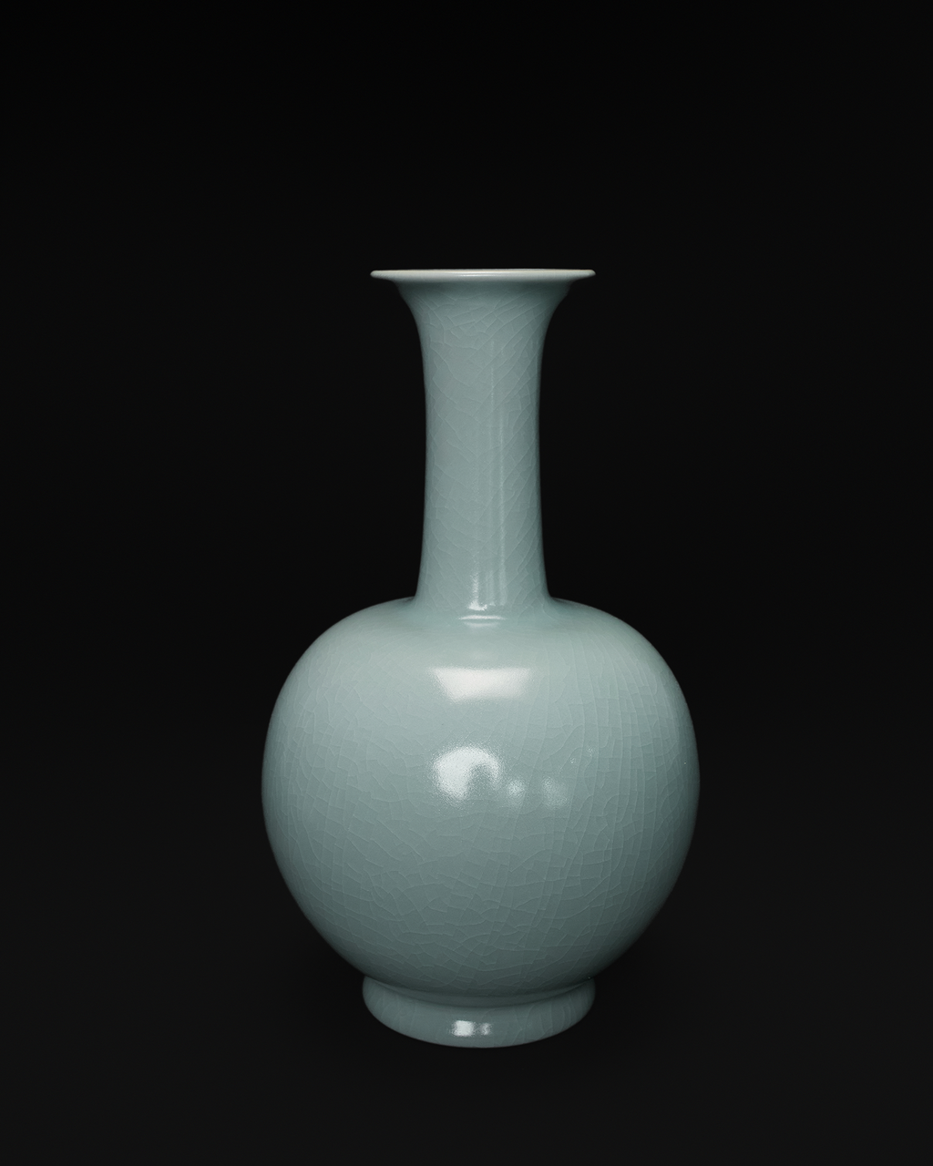 Front view of a celadon long neck vase with a flared rim, slender neck and rounded body.