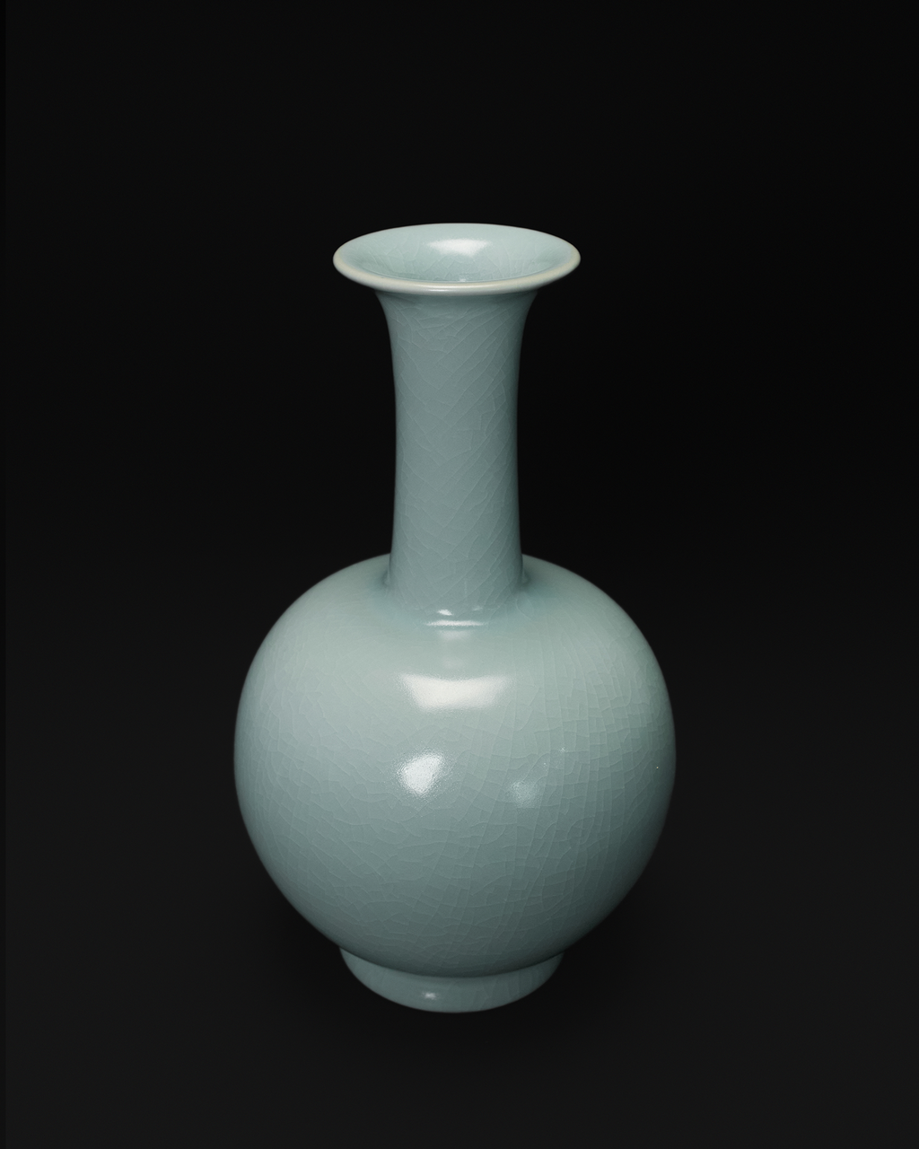 Three-quarter view of the long neck vase showing its flared mouth and spherical body.