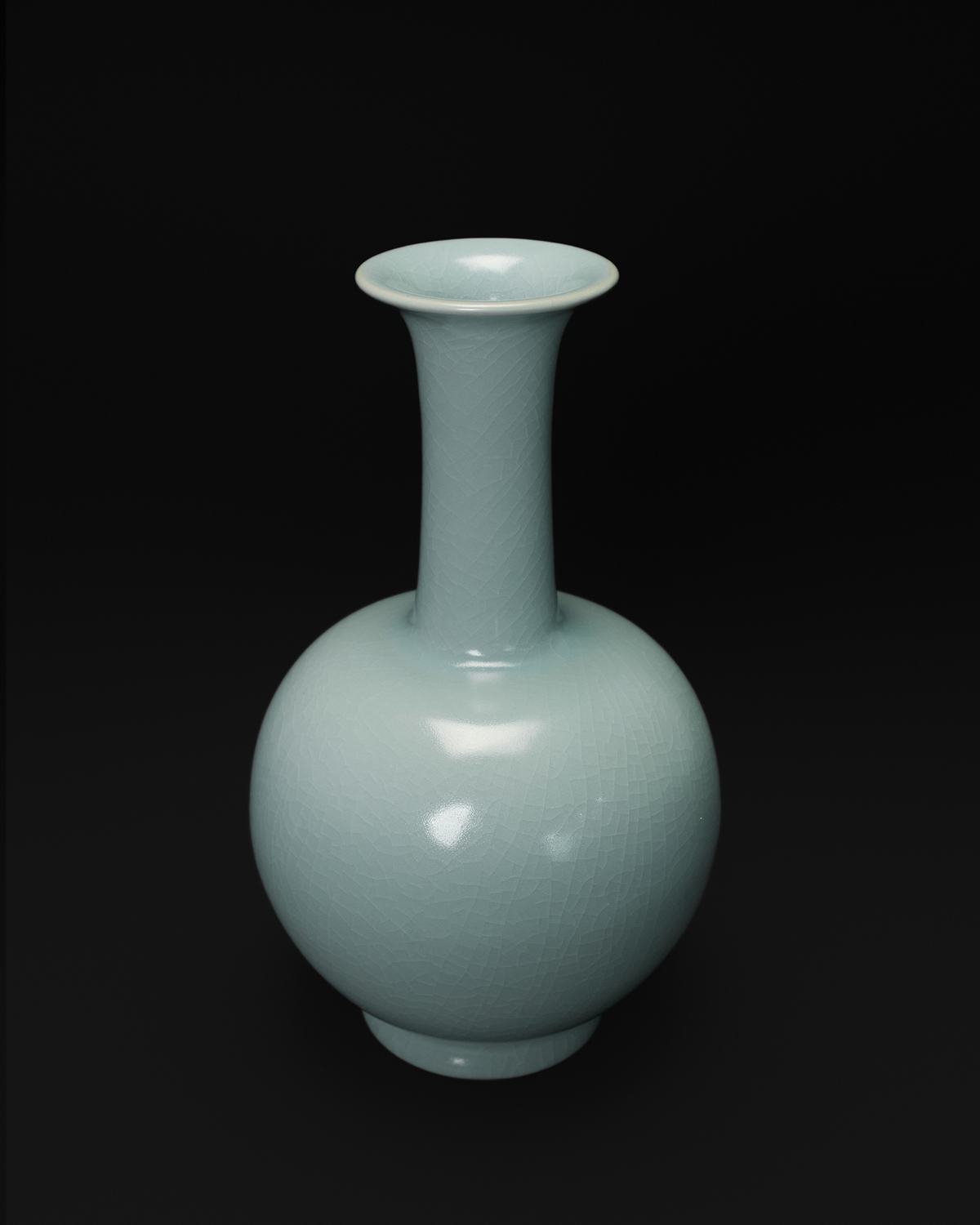 Three-quarter view of the long neck vase showing its flared mouth and spherical body.