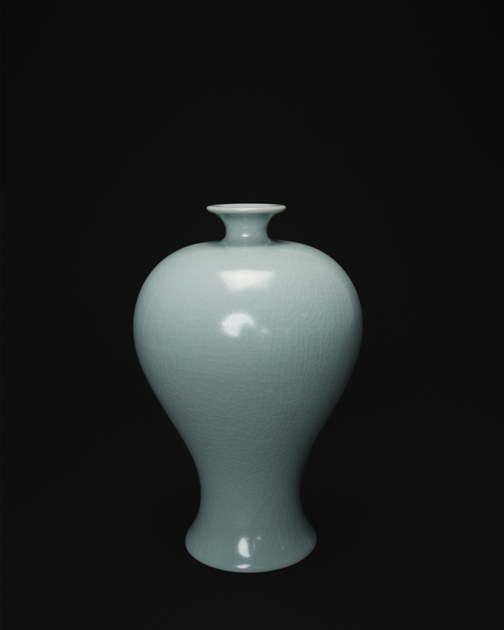 Front view of a celadon Meiping vase with a small flared mouth, rounded shoulders and tapered body.