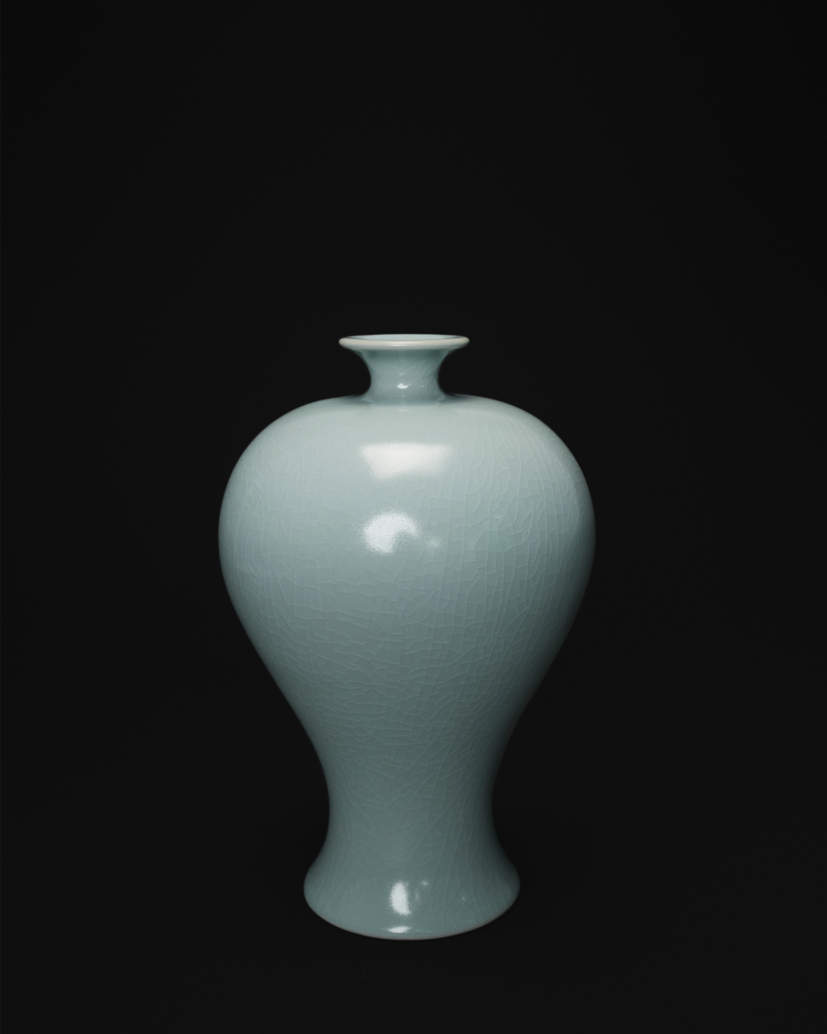 Front view of a celadon Meiping vase with a small flared mouth, rounded shoulders and tapered body.