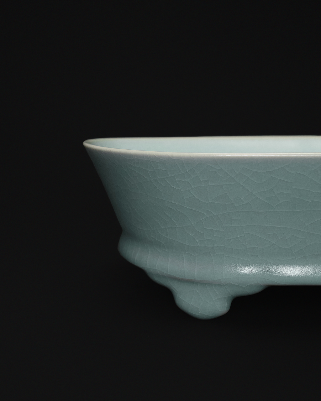 Close-up of the crackle celadon glaze and one raised foot on the narcissus basin.