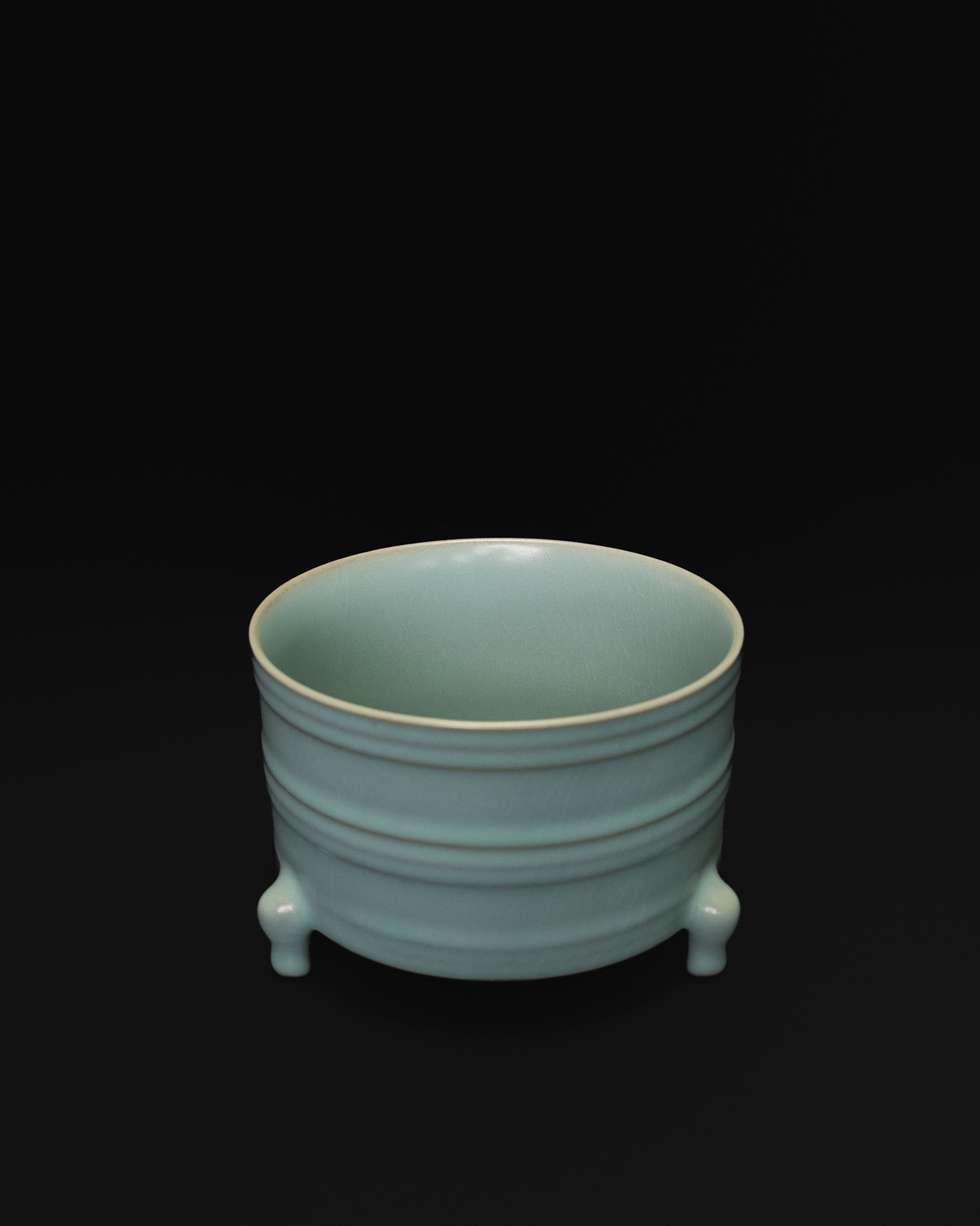 Three-quarter view of the ribbed ceramic vase showing its open interior and raised bands.