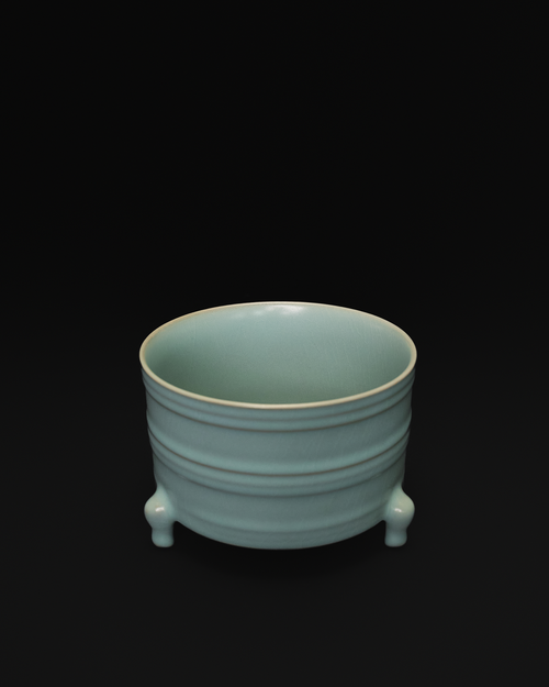 Three-quarter view of the ribbed ceramic vase showing its open interior and raised bands.