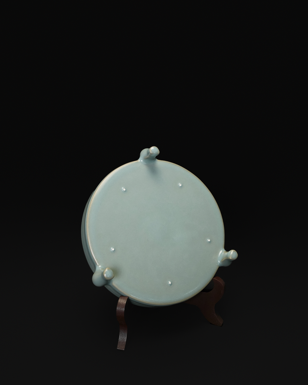 Underside view of the tripod bowl showing all three feet and visible firing spur marks.