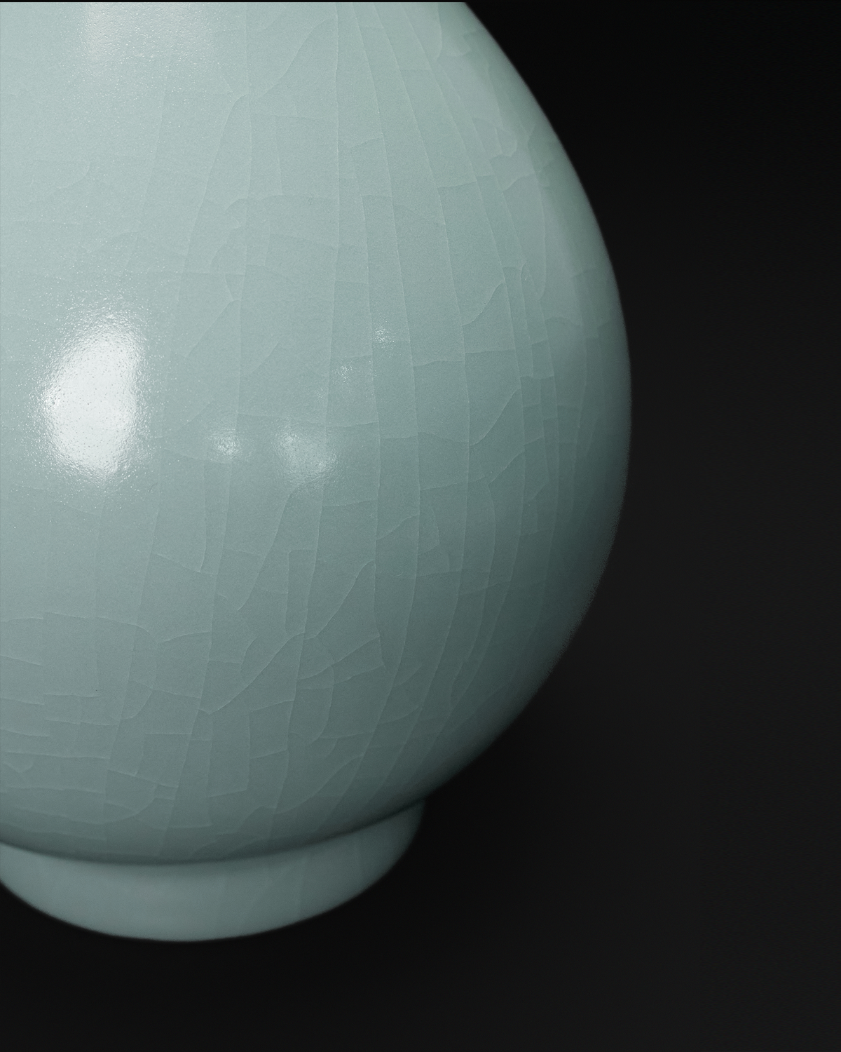 Close-up of the crackle celadon glaze across the rounded body and foot of a Yuhuchun vase.